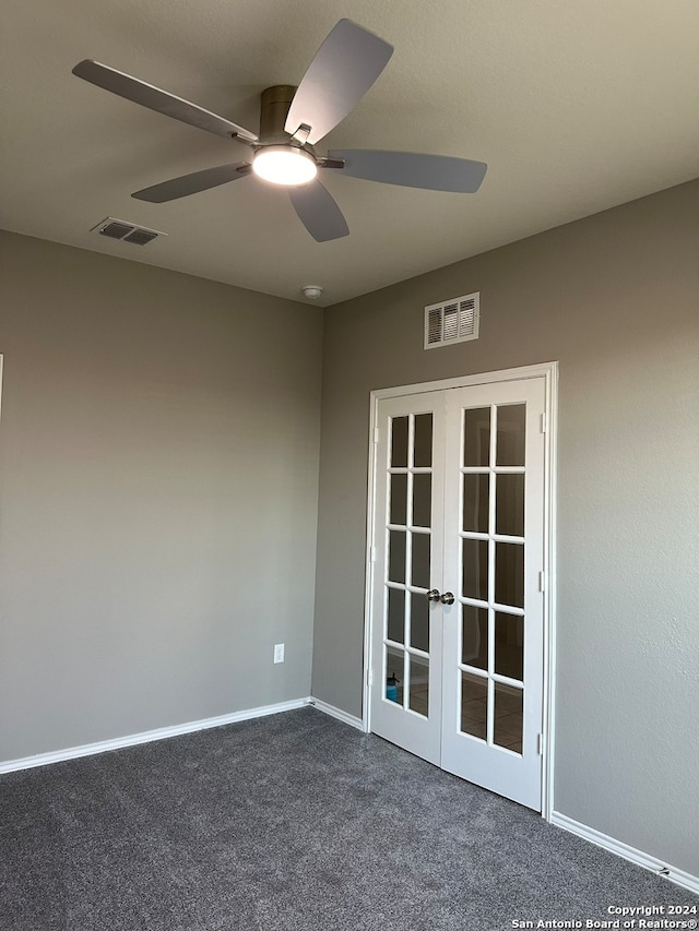 carpeted empty room featuring french doors and ceiling fan