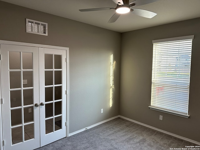 unfurnished room with french doors, carpet floors, and ceiling fan