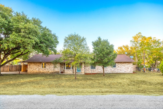 ranch-style home with a front lawn