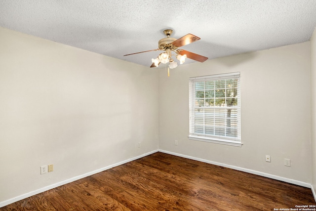 empty room featuring ceiling fan, dark hardwood / wood-style flooring, and a textured ceiling