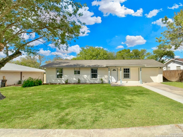 single story home with a garage and a front lawn