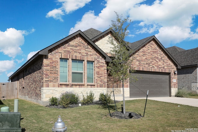 view of front of home with a front yard and a garage