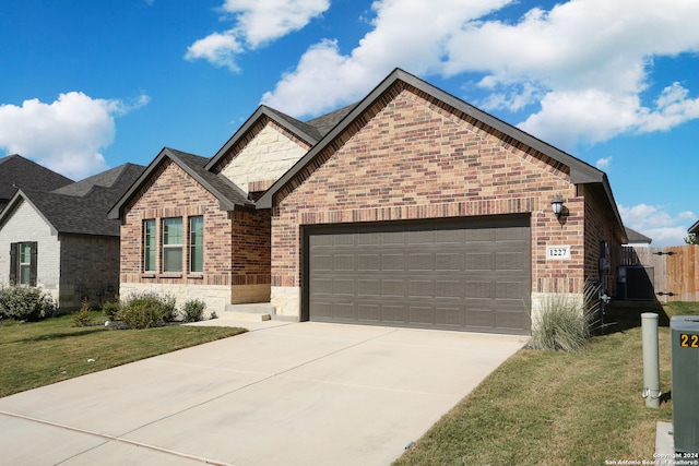 view of front of house with a front yard and a garage