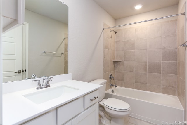 full bathroom with vanity, toilet, tiled shower / bath combo, and tile patterned flooring