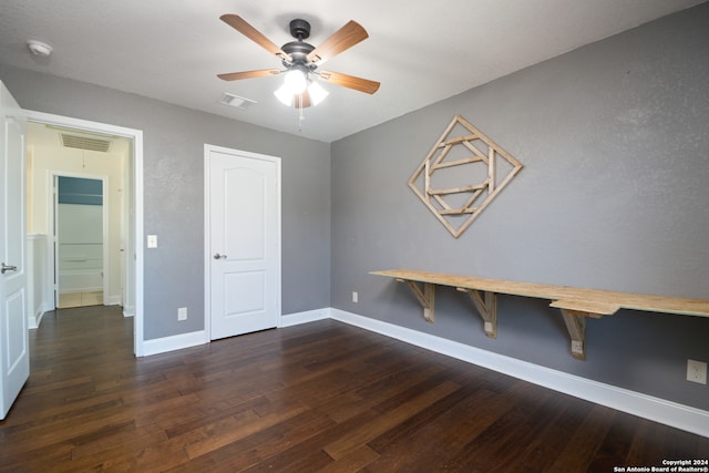 interior space featuring dark wood-type flooring and ceiling fan