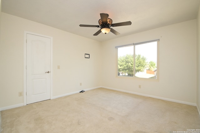 carpeted spare room with ceiling fan