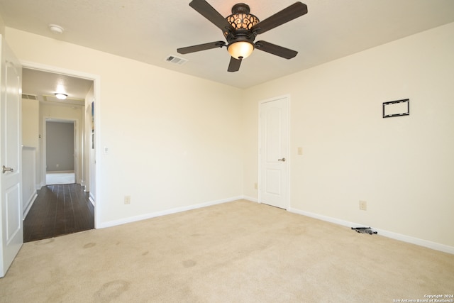 spare room with light carpet and ceiling fan