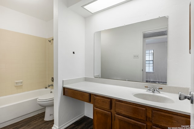 full bathroom featuring vanity, toilet, tiled shower / bath, and hardwood / wood-style floors