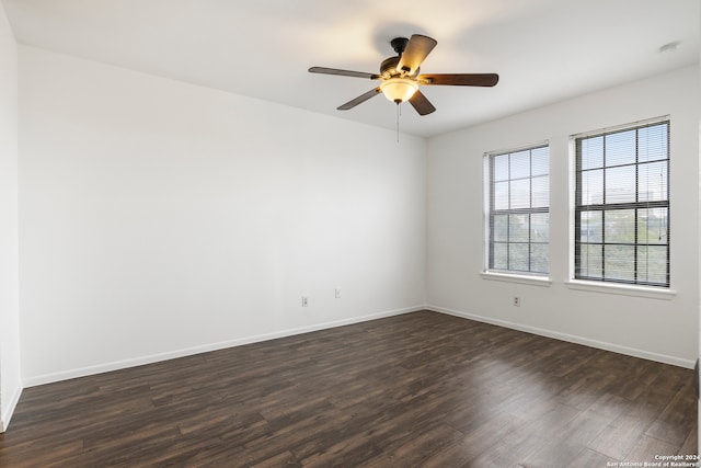 empty room with ceiling fan and dark hardwood / wood-style flooring