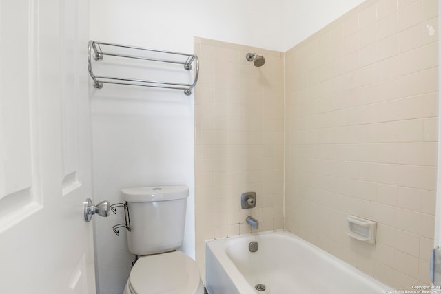 bathroom with toilet and tiled shower / bath combo