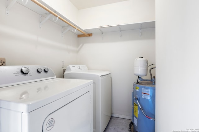 washroom with water heater and washer and dryer