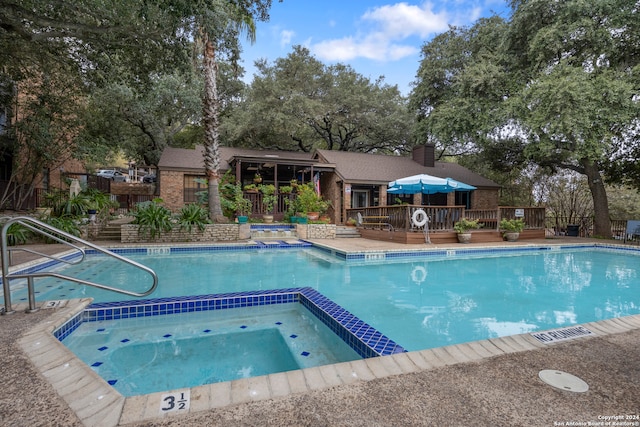 view of swimming pool featuring a deck