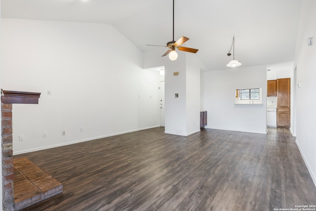 unfurnished living room featuring dark hardwood / wood-style floors, high vaulted ceiling, a fireplace, and ceiling fan