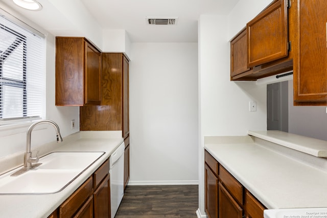 kitchen featuring white dishwasher, sink, and dark hardwood / wood-style flooring