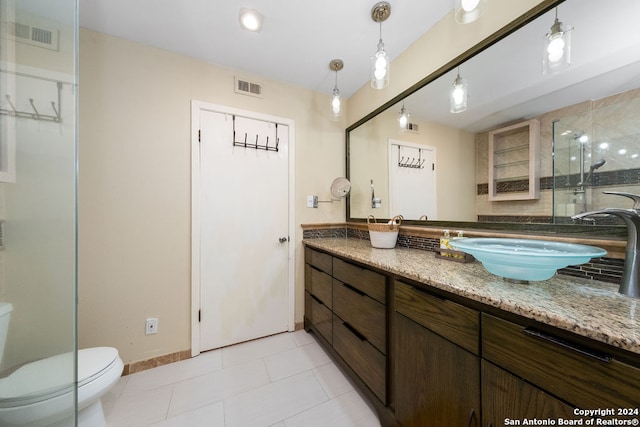 bathroom with vanity, toilet, and tile patterned flooring