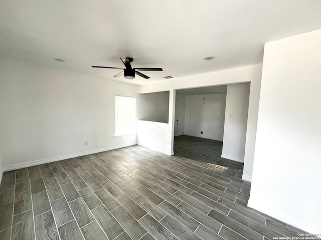 empty room with dark wood-type flooring and ceiling fan