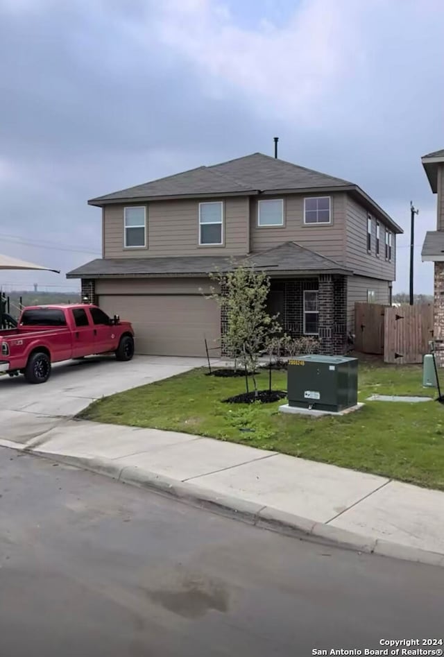 view of front of home featuring a front yard and a garage