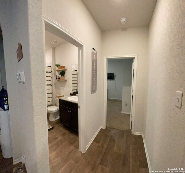 hall with sink and dark hardwood / wood-style flooring