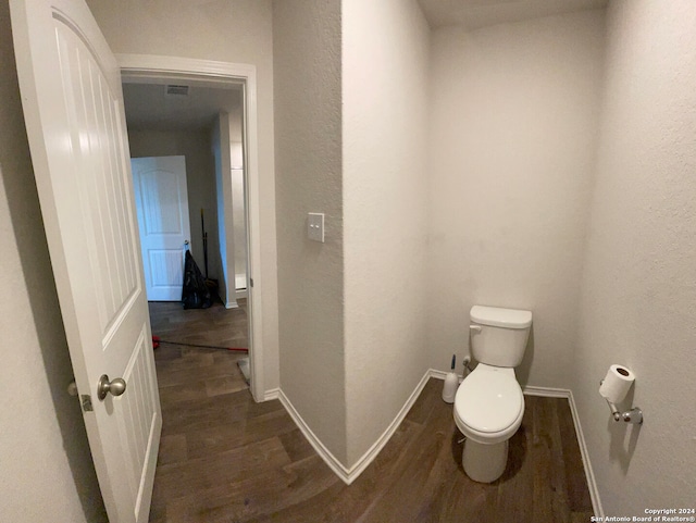 bathroom with toilet and hardwood / wood-style flooring