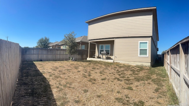 rear view of house with a yard and a patio area