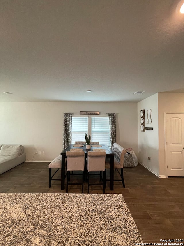 dining area featuring dark hardwood / wood-style floors