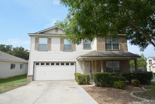 view of front property featuring a porch and a garage