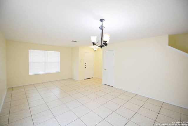 interior space featuring light tile patterned flooring and a chandelier