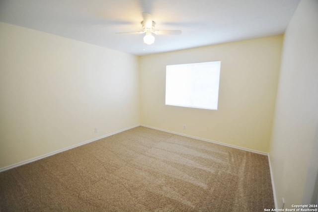 unfurnished room featuring carpet and ceiling fan