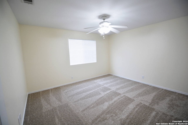 empty room with carpet floors and ceiling fan