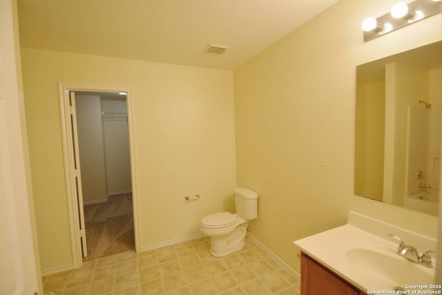 bathroom with vanity, a tub, and toilet