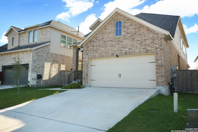 view of side of property featuring a yard and a garage