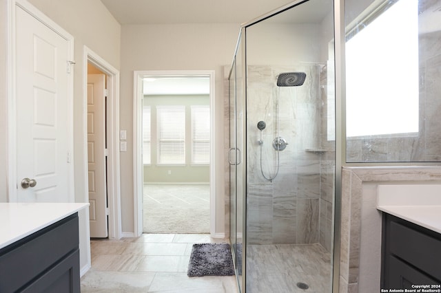 bathroom featuring vanity, tile patterned floors, plenty of natural light, and an enclosed shower