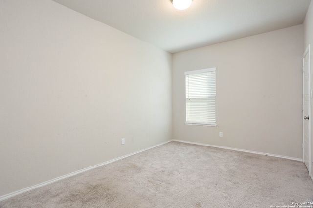 unfurnished room featuring light carpet