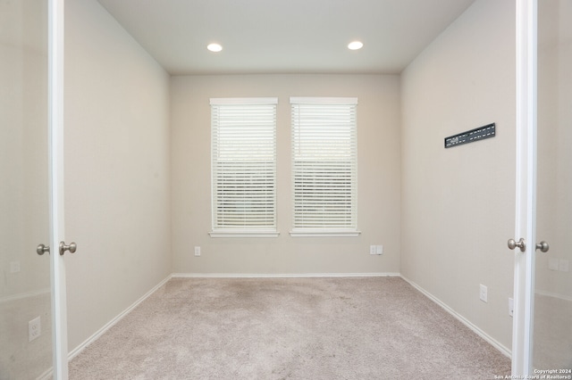 spare room with light colored carpet