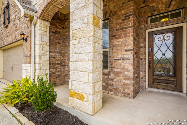 doorway to property with a garage