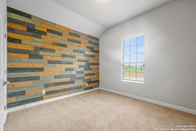 spare room with lofted ceiling and light carpet