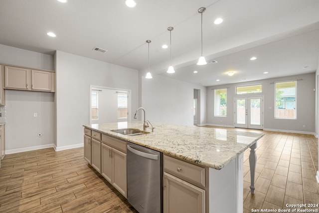 kitchen featuring an island with sink, light wood-type flooring, dishwasher, french doors, and sink