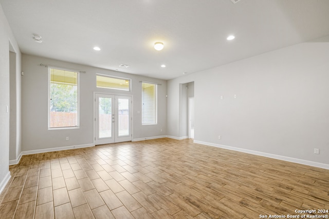 unfurnished room featuring french doors and light wood-type flooring