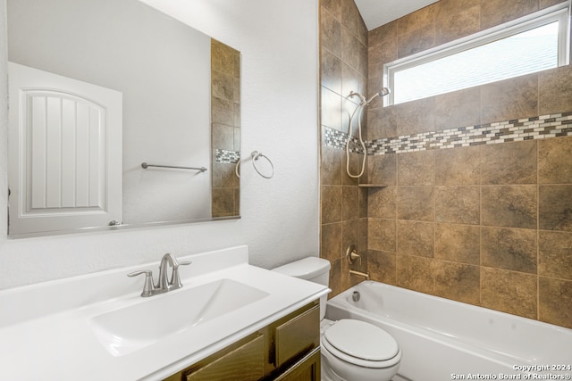 full bathroom featuring toilet, tiled shower / bath combo, and vanity