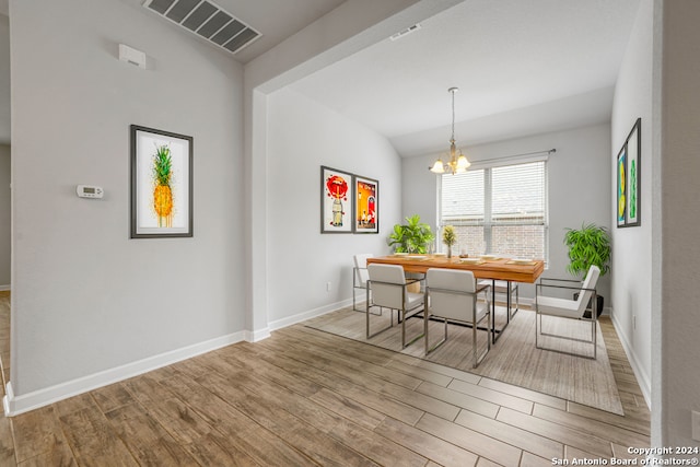 dining space with a chandelier and light wood-type flooring