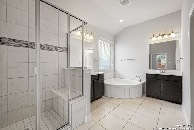 bathroom featuring vanity, independent shower and bath, vaulted ceiling, and a healthy amount of sunlight