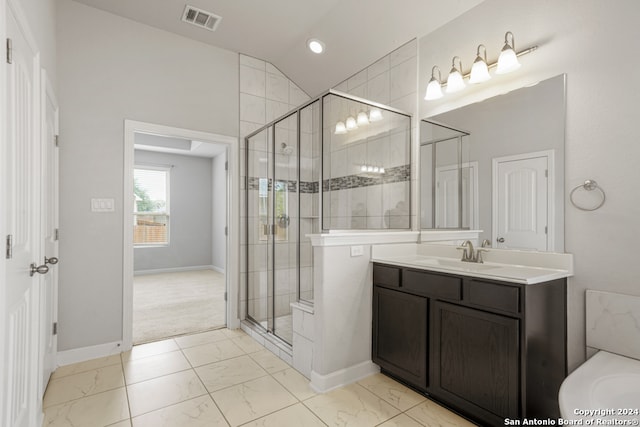 bathroom with vanity, walk in shower, and vaulted ceiling