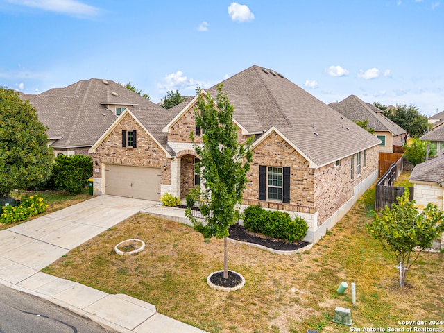 front of property featuring a front lawn and a garage