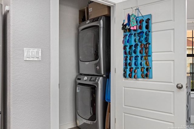 laundry area featuring stacked washing maching and dryer