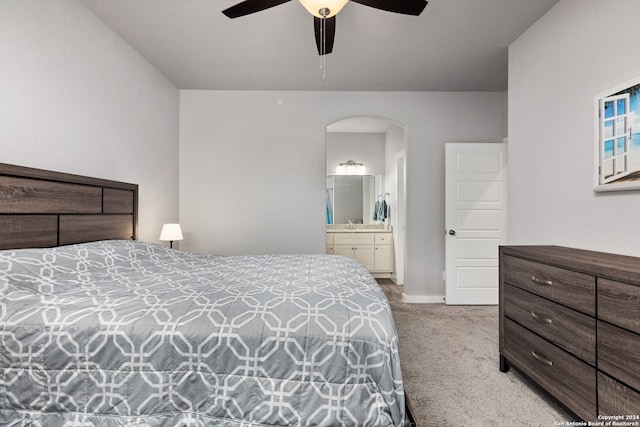 carpeted bedroom featuring ensuite bathroom and ceiling fan