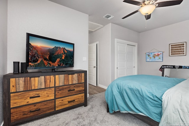 bedroom with a closet, ceiling fan, and carpet floors