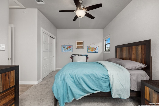 carpeted bedroom featuring a closet and ceiling fan