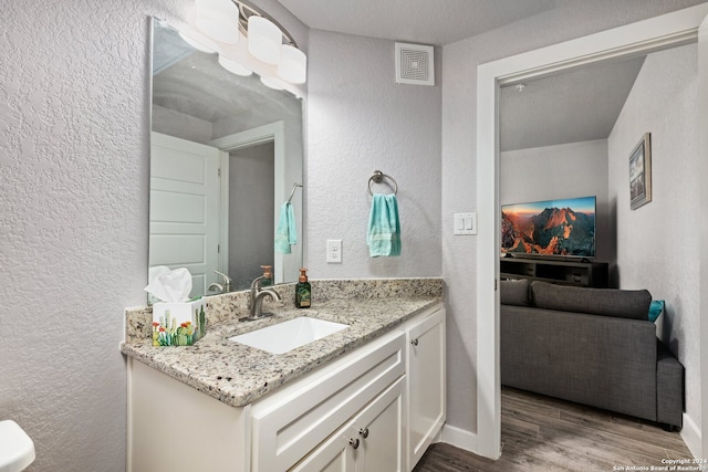 bathroom featuring vanity, a textured ceiling, and hardwood / wood-style flooring