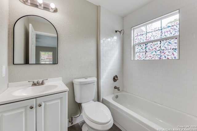 full bathroom with vanity, tiled shower / bath combo, and toilet