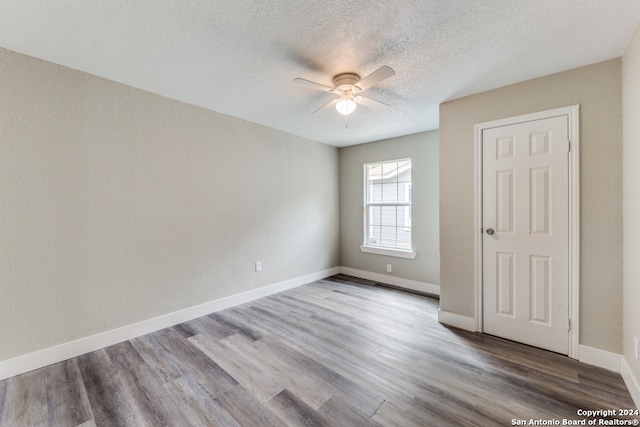 unfurnished room featuring hardwood / wood-style floors, a textured ceiling, and ceiling fan